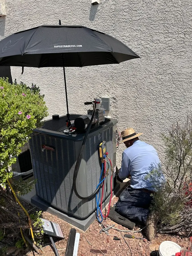HVAC technician performing outdoor AC maintenance in North Berwick